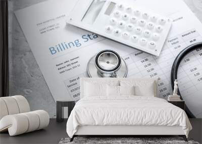 medical treatmant billing statement with stethoscope and calculator on stone background Wall mural