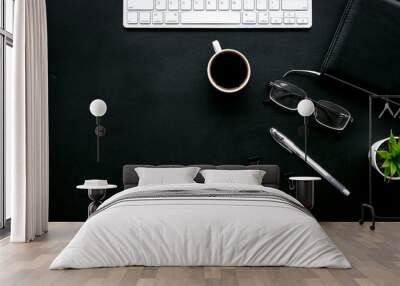 Office desk of chief, director or top manager. Computer keyboard, expensive black notebook, glasses, coffee on black background top view copy space Wall mural