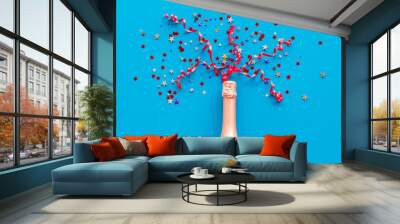 Party with champagne bottle and colorful party streamers on blue background top view Wall mural