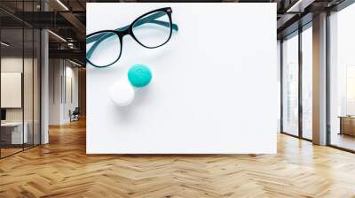 Products help see better. Glasses with transparent optical lenses and eye lenses on white background top view copy space closeup Wall mural