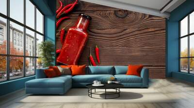 Red chili pepper sauce in bottle with ripe hot pepper Wall mural