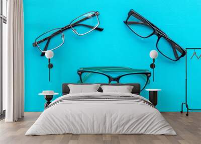 Set of glasses with transparent lenses on blue background top view Wall mural