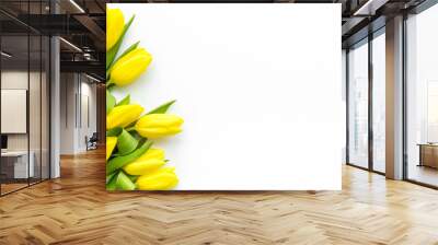 Spring composition. Delicate yellow tulips on white background top view space for text border Wall mural