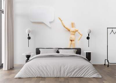 Wooden man figure presenting and showing on speech bubble banner Wall mural