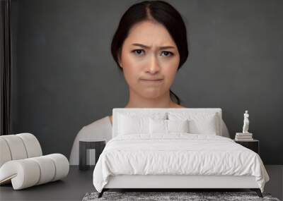 face portrait of sad unhappy girl; portrait of upset angry frustrated Chinese or east asian woman; young adult Chinese asian woman model Wall mural