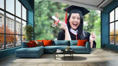 happy excited college student graduating; concept of successful education, happy commencement day, woman education equality, employment opportunity, high education degree, overseas study scholarships Wall mural