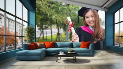 happy successful smiling woman university student graduating; portrait of diploma or college woman student with graduation degree, education concept; asian 20s young adult woman model Wall mural