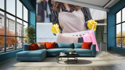 happy woman holding laundry basket Wall mural