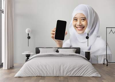 Muslim woman catering business owner showing smartphone blank screen, concept image for food and beverage, F&B, catering order mobile app or application Wall mural