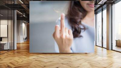 rude woman hand giving middle finger to you; negative angry upset failed asian woman showing offensive, rude, f, vulgar middle finger hand gesture; asian woman young adult hand model Wall mural