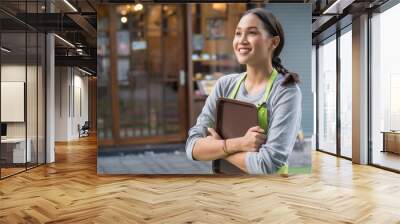 smiling happy small business owner, entrepreneur, shop manager looking up and thinking with positive mood, bright future or profit concept Wall mural