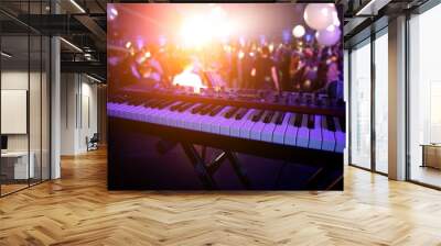 Piano keys in purple light on concert stage. Synthesizer. Wall mural