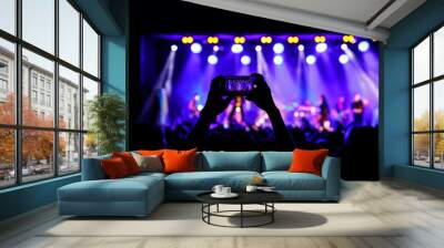 Streaming a music concert to social media via smartphone. Wall mural