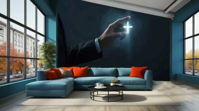 Hand Holding a Glowing Cross Wall mural