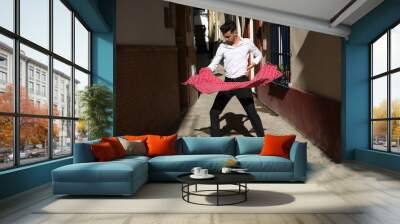 flamenco and gipsy man, dressed in black and white shirt dancing with a polka-dotted handkerchief in his hand in an alley in the streets of a Mediterranean city. Flamenco cultural heritage of humanity Wall mural