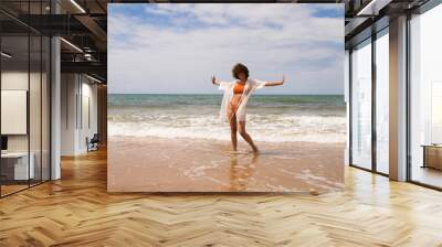 happy woman jumping on the beach Wall mural