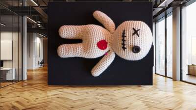 voodoo doll lying on a black background. Wall mural