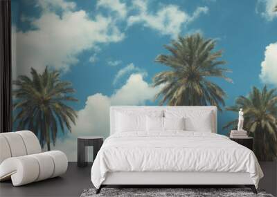 Blue sky and palm trees view from below, vintage style, tropical beach and summer background, travel concept Wall mural