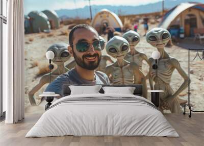 Happy guy taking selfie with group of aliens. Wall mural