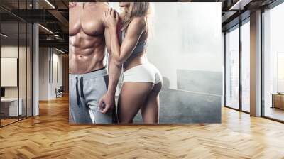 beautiful young sporty sexy couple in gym Wall mural