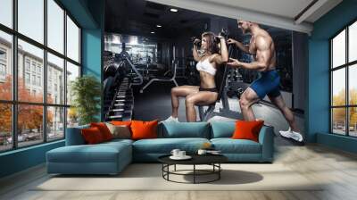 beautiful young sporty sexy couple in gym Wall mural