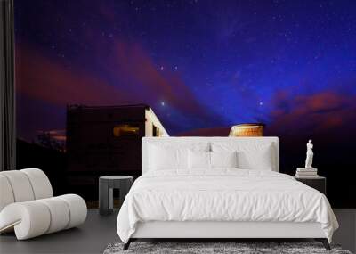 Campervans are parked on a beach at night under stars. Wall mural