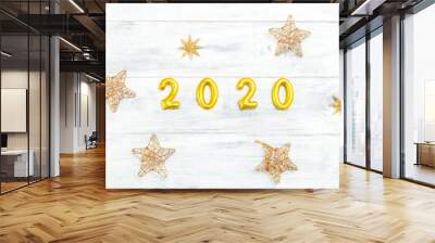 2020 New Year shiny golden color and stars on white wooden background. Flat lay Wall mural