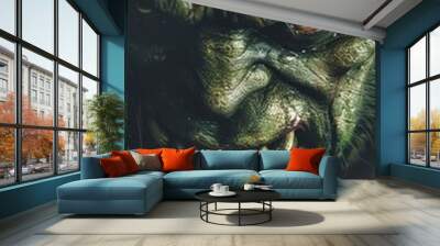 A menacing green goblin displays sharp fangs and glowing eyes in a shadowy atmosphere Wall mural