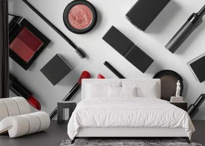 Vibrant makeup products are organized neatly on a white surface, highlighting their colors and packaging Wall mural