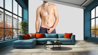 Close up of a muscular male torso on a gray background. Wall mural