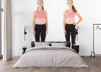 Two figures of the same model, young fitness woman full growth isolated over white background. Wall mural