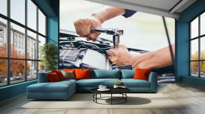 automobile mechanic repairman hands repairing a car engine automotive workshop with a wrench, car se Wall mural