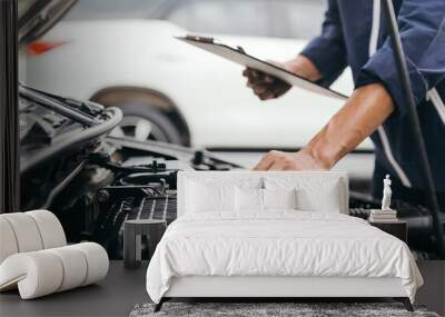 Automobile mechanic repairman hands repairing a car engine automotive workshop with a wrench, car service and maintenance,Repair service. Wall mural