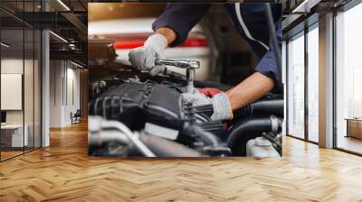 Automobile mechanic repairman hands repairing a car engine automotive workshop with a wrench, car service and maintenance,Repair service. Wall mural