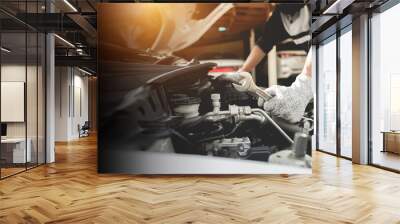 Automobile mechanic repairman hands repairing a car engine automotive workshop with a wrench, car service and maintenance,Repair service. Wall mural