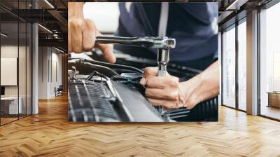 Automobile mechanic repairman hands repairing a car engine automotive workshop with a wrench, car service and maintenance,Repair service. Wall mural