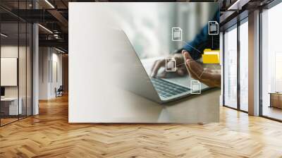 Businessman using computer laptop , holding folder and document icon software, searching and managing files online , database and document management system concept. Wall mural