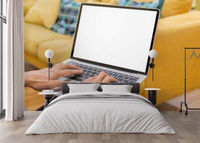 Mockup image of a businessman using laptop with blank white desktop screen working in home- Image Wall mural