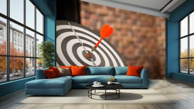 Red dart arrow hitting in the target center of dartboard on bullseye with sun light vintage style, Target marketing and business success concept - Image. Wall mural