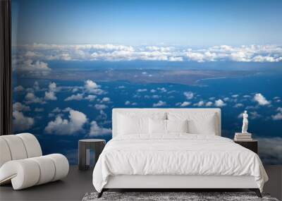 Aerial view of Hawaiian island of Molokai and its western coast against blue sky with clouds Wall mural