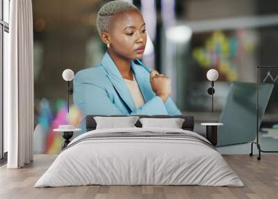 Laptop, idea and a serious business black woman in her office on a review, proposal or project. Work, focus and thinking with a female employee reading an email or doing research while working Wall mural