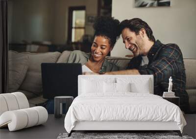 Laptop, interracial and entertainment with a couple watching a video using an online subscription service to relax. Computer, streaming or internet with a man and woman bonding together over a movie Wall mural