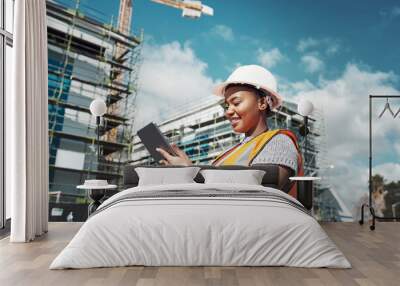 Outdoor, business an black woman with a tablet, construction site and update schedule for new project. Female person, employee or inspector with technology, check progress or architecture with growth Wall mural