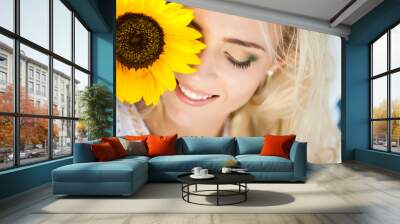 portrait of attractive woman with sunflowers in her hand Wall mural