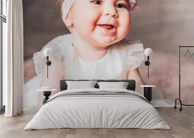 Cute Portrait of smiling happy 7 month old baby girl in white dress. Closeup. Stay Home. Wall mural