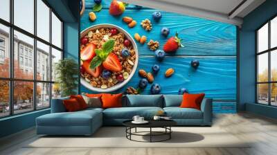 Blue surface with fresh fruit and granola with nuts, healthy breakfast concept Wall mural