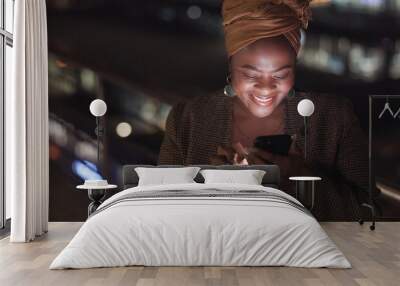 City, rooftop and black woman on a phone at night networking on social media or the internet. Technology, happiness and African lady browsing online with a cellphone on an outdoor balcony in a town. Wall mural