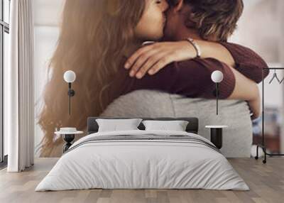 Couple, hug and kiss in home for love, care and bonding for quality time together with trust, loyalty and happiness. Happy young man, woman and kissing for affection, romance or intimate relationship Wall mural