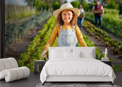 Little girl, farm and agriculture in green harvest for sustainability, organic and production in nature. Portrait of child holding crops in sustainable farming in the countryside for natural resource Wall mural