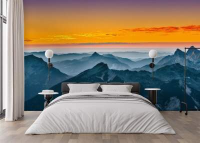 view over blue mountains with golden yellow sunset sky Wall mural